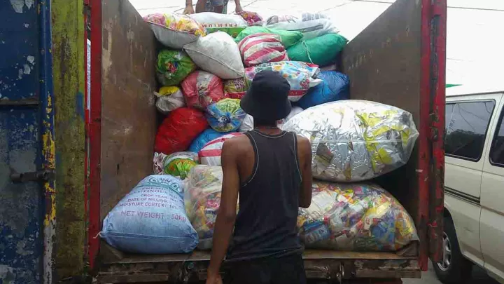 Mann vor Müllwagen auf den Philippinen