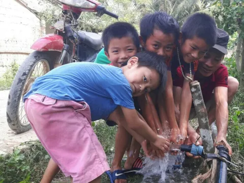 Kinder in Vietnam an einem Wasserhahn