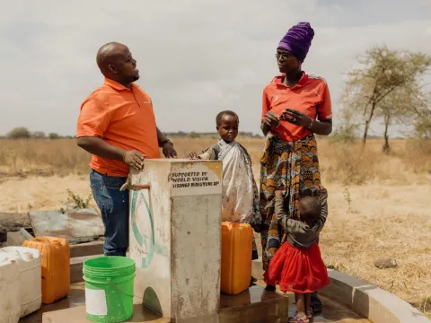 World Vision Mitarbeiter am Wasserbrunne