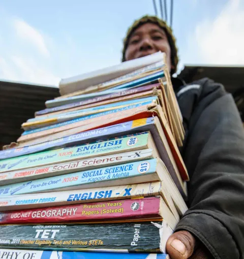 Youth with a bunch of books to study