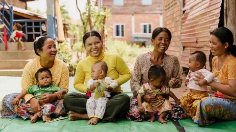 Frauengruppe mit Kleinkindern und Babys, Aufklärungsarbeit für werdende Mütter
