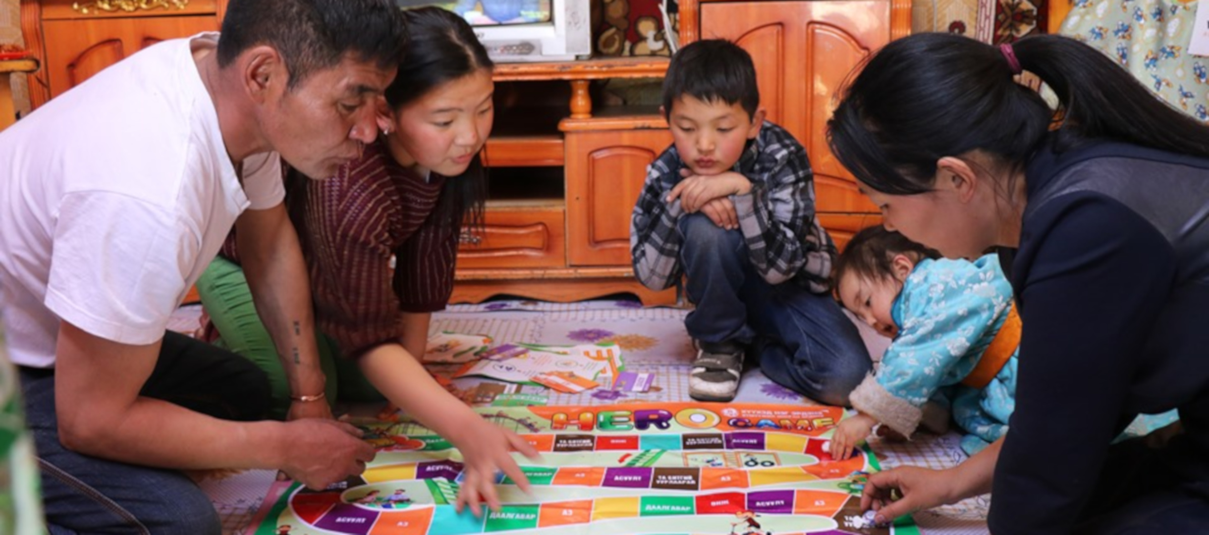 Familie in der Mongolei spielt gemeinsam das World Vision Brettspiel.