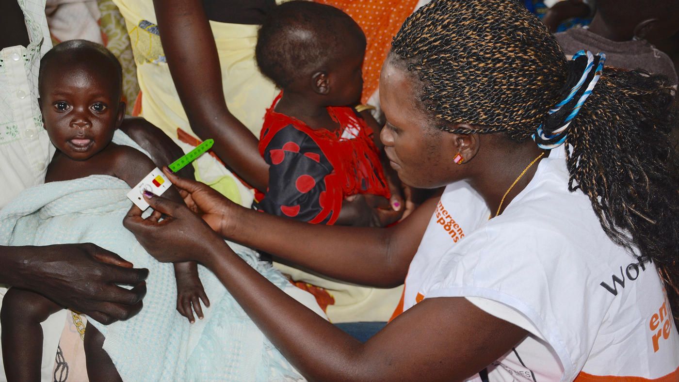 Eine Mitarbeiterin von World Vision kontrolliert bei einem Kind im Südsudan den Ernährungszustand.