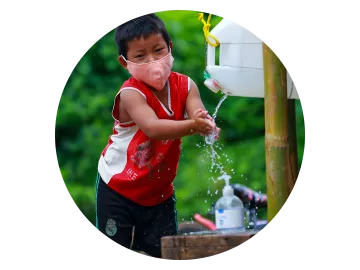 Kind wäscht seine Hände an einem Tippy Tappy