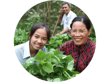 Mit einer Patenschaft eine Familie unterstützen: Mutter und Tochter ernten Gemüse in ihrem Garten