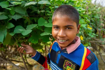 Junge im Gemüsegarten in Indien