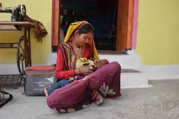 Mutter stillt ihr Kind  in Pratapgarh