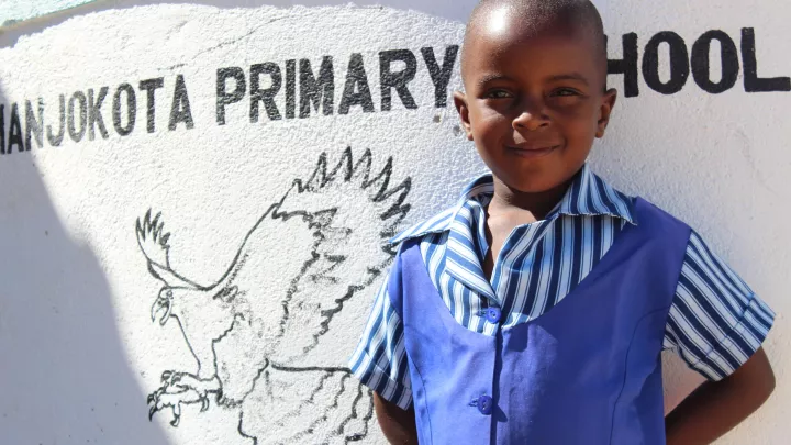 Ein Schulkind in Simbabwe, das sich auf die Wieder-Eröffnung seiner frisch renovierten Grundschule freut