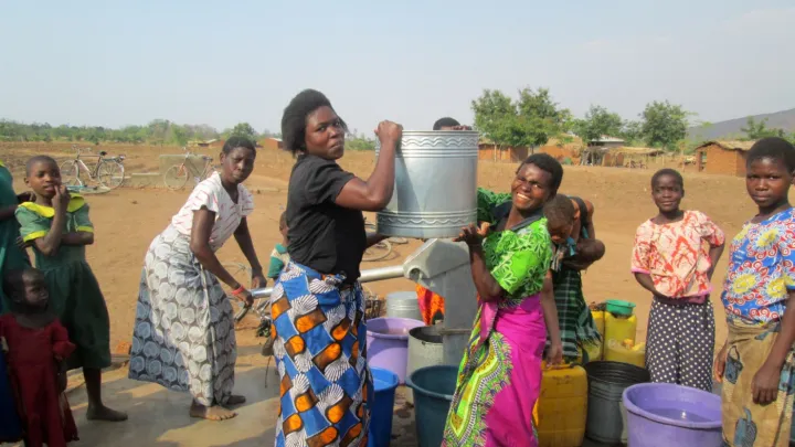 Arbeitende Menschen und Frau mit Wassereimer