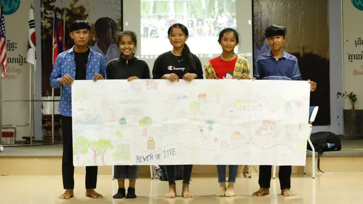 Kinder aus Kambodscha halten ein Bild des Projekts