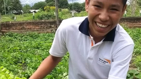 Eine Junge zeigt die erfolgreiche Ernte