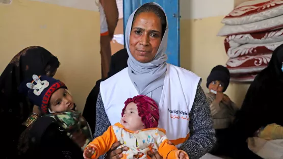Asuntha Charles hält ein Kleinkind